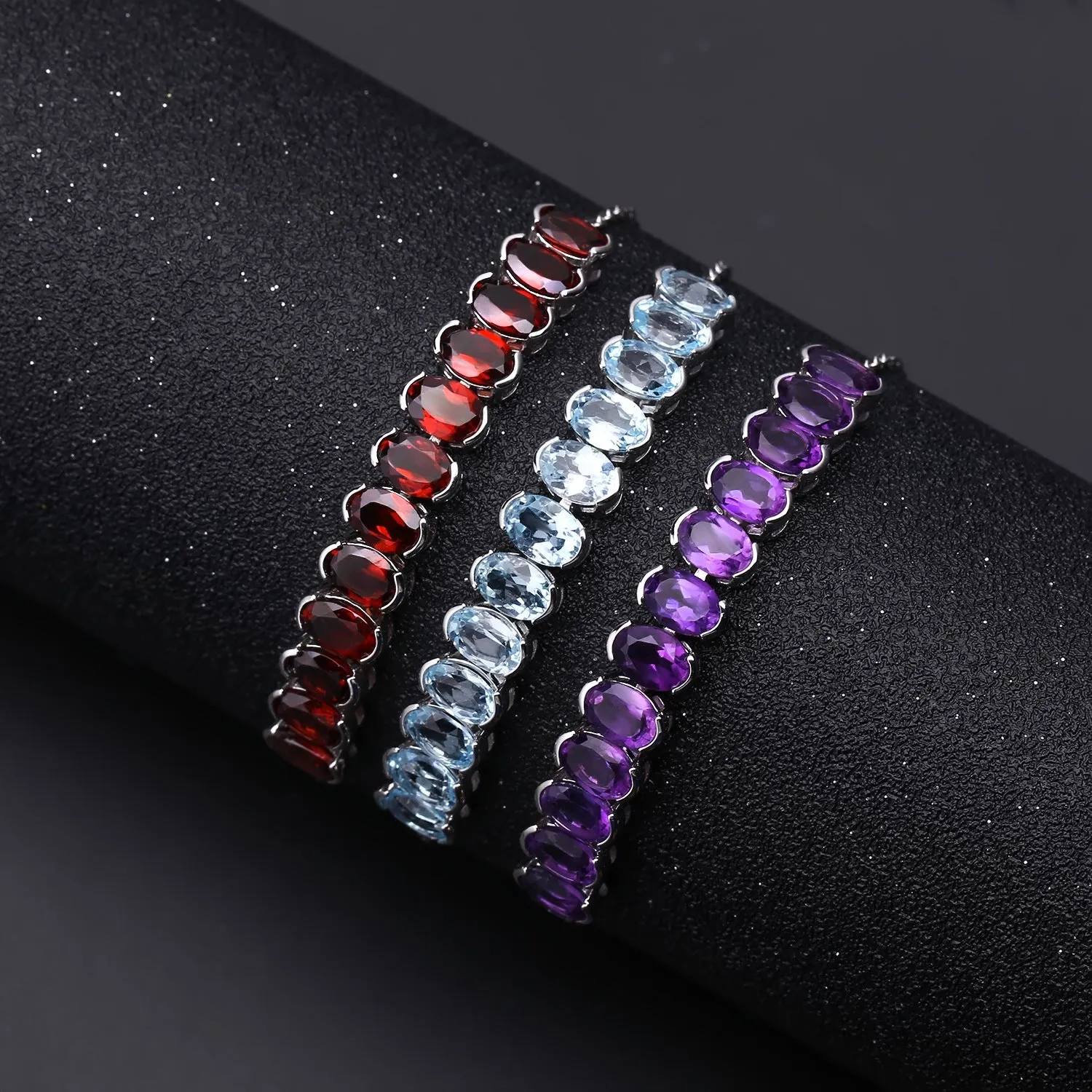 A Row of 12 Oval Shape Gemstones Silver Bracelet