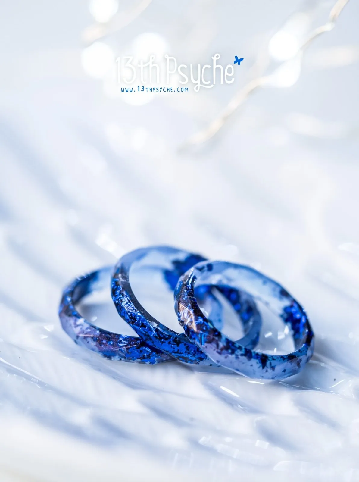 Light blue faceted resin ring with blue flakes